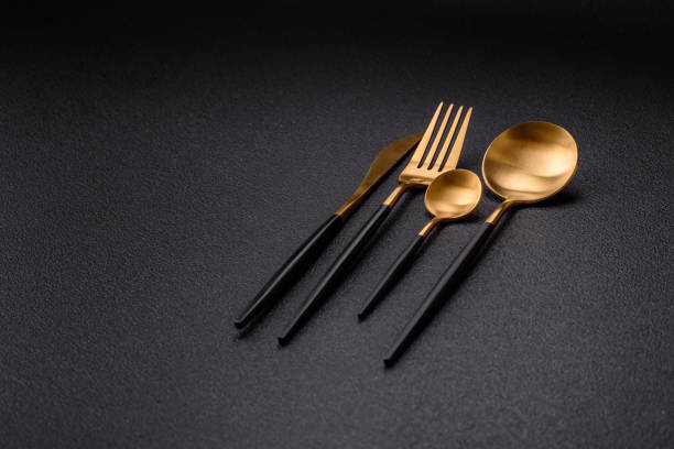 istock Cutlery fork, knife and spoon on a dark textured concrete background 2066325456