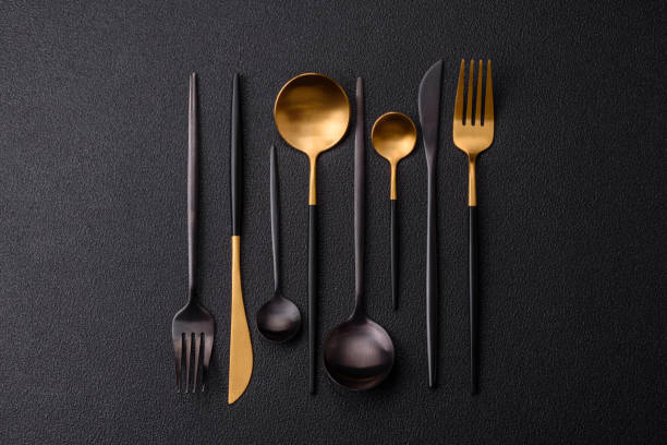 istock Cutlery fork, knife and spoon on a dark textured concrete background 2066327706