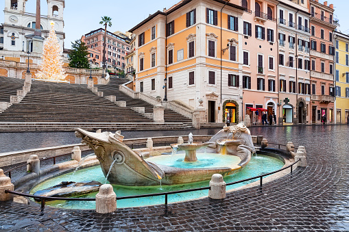Piazza di Spagna, Fontana della Barcaccia and Spanish steps in the morning in Rome, Italy.  Famous square in Rome, Italy. Rome architecture and landmark.