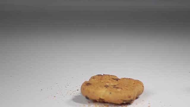 cookie falling bouncing on table slow motion