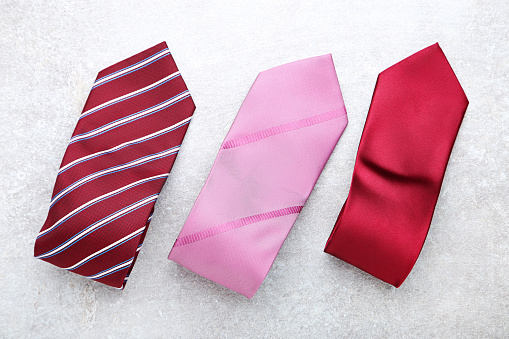 Colorful neckties on grey background