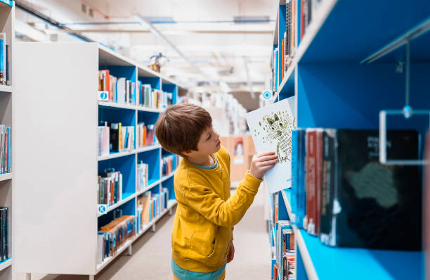 Young kid portrait at the public library Note: (Illustration of Cat on the book backcover is my own artwork)