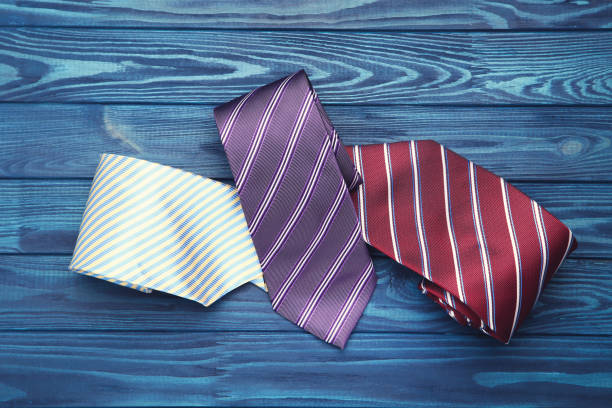 istock Colorful neckties on blue wooden table 2066369675