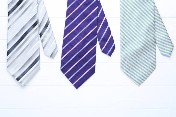 Many different ties of multi colors on display at the exhibition showcase. Large assortment of items for customers to choose from.