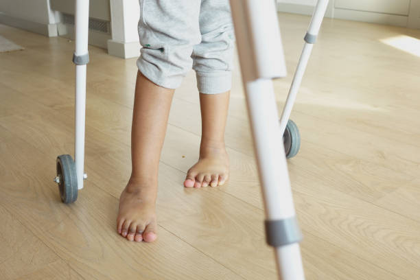 istock child with walking frame and knee orthosis indoor 2066376487