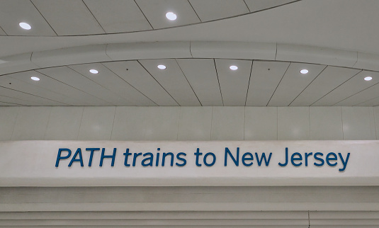 New York, NY - March 2, 2024: PATH trains to New Jersey sign on the wall at the World Trade Center train station in lower Manhattan, New York City.