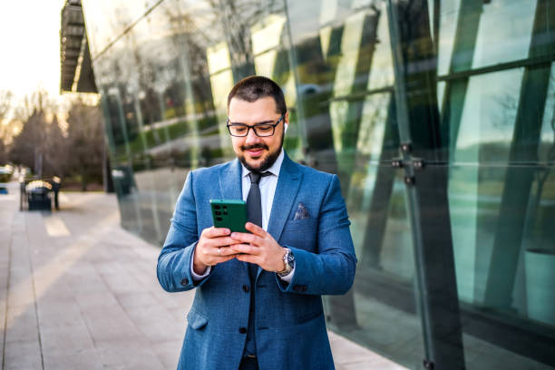 istock Businessman using phone outdoors 2066441740