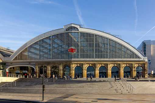 View of lime street station in the centre of Liverpool, UK.  People can be seen on the promenade.