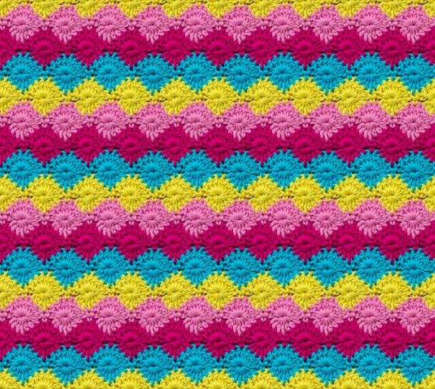 istock Seamless knitted texture in the form of daisies. The pattern is crocheted from multicolored cotton yarn. 2066448523