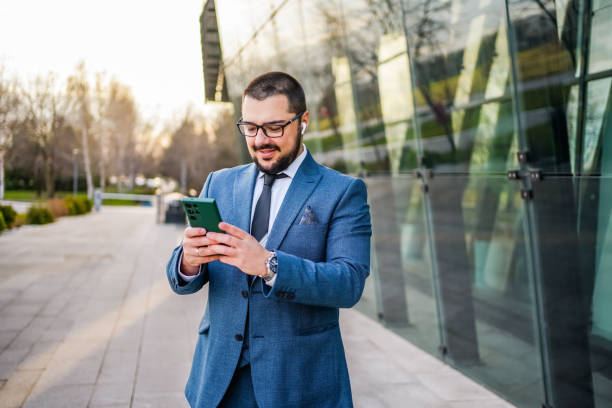 istock Businessman using phone outdoors 2066449035