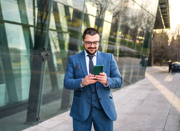 istock Businessman using phone outdoors 2066449570