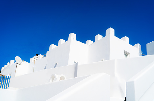 traditional greek village of Santorini, white walls against blue sky