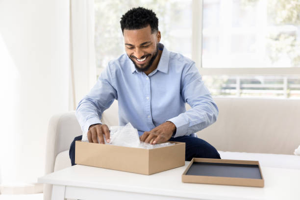 istock Cheerful young African consumer man getting parcel 2066487304