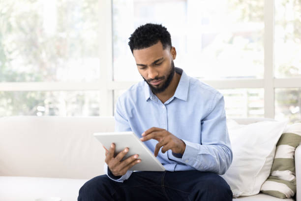 istock Serious African entrepreneur man using tablet for job communication 2066488851