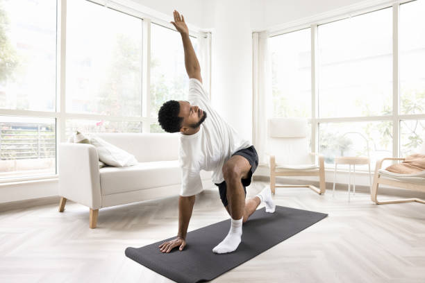 istock Serious young Black man doing morning exercises at home 2066500964