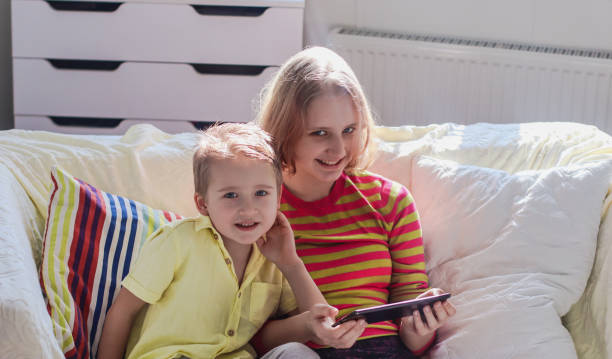 istock brother with his older sister in a bright room 2066507190