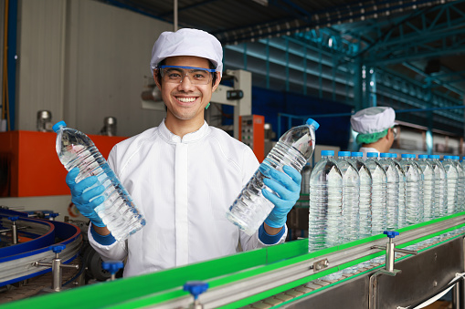 At the drinking water factory, a young worker is pictured working during the water production process.