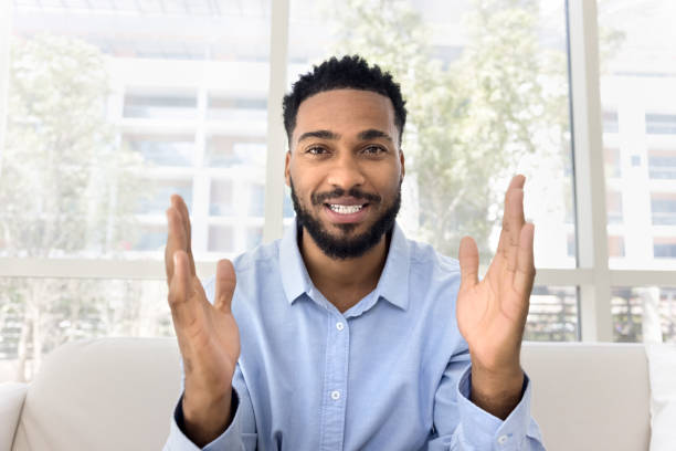 istock Positive attractive African influencer guy speaking at camera 2066533317