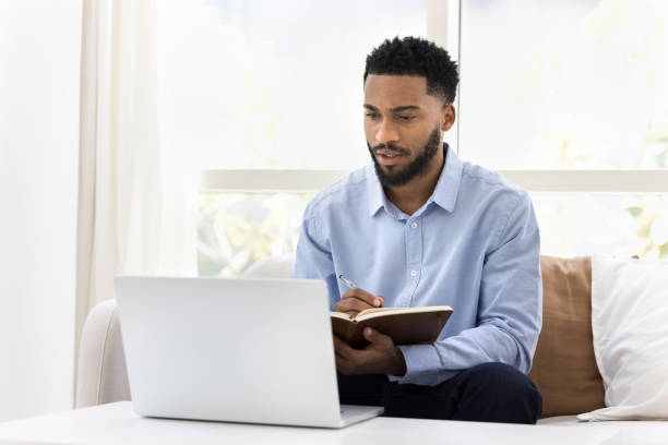 istock Serious African student man watching online lecture, training seminar 2066539643