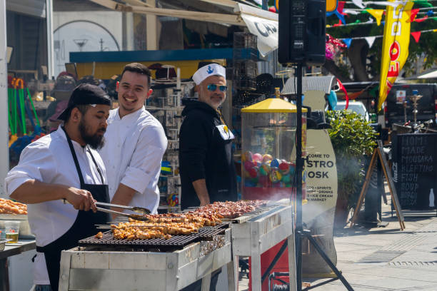 Limassol, Cyprus, March 7th, 2024: Men grilling meat for street party at Tsiknopempti (Smokey Thursday) in Old Town