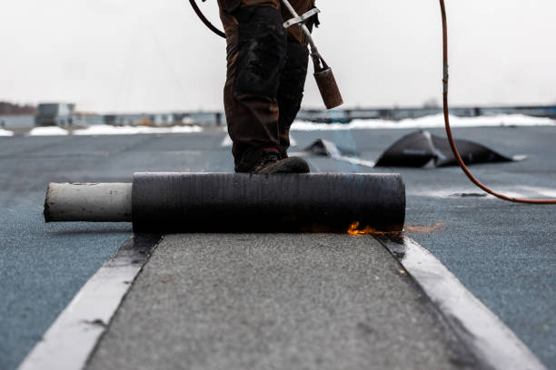 istock professional roofer at work securing rolled tar paper with a blowtorch on a flat roof installation process 2066589974