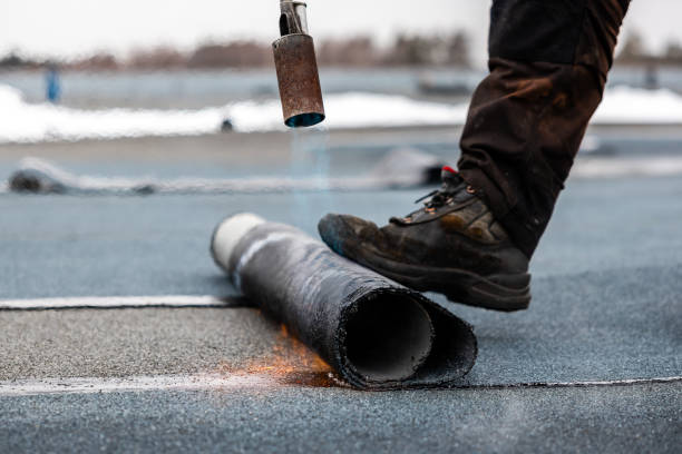 istock professional roofer at work securing rolled tar paper with a blowtorch on a flat roof installation process 2066589980