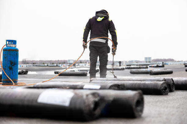istock professional roofer applying bitumen roll on flat roof with a gas burner at a modern construction site 2066589984