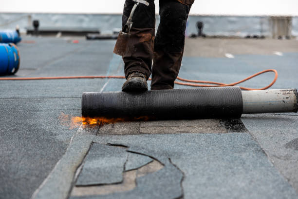 istock professional roofer at work securing rolled tar paper with a blowtorch on a flat roof installation process 2066589993