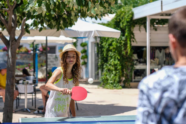 istock girl outside playing table tennis with hat 2066592598