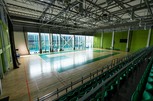 Contemporary Athletic Facility with Multi-Sport Court, Spectator Seating, and Large Windows
