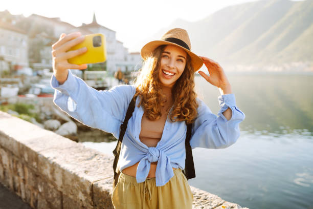 istock Happy tourist walks the streets and takes selfie using smartphone camera. 2066604649