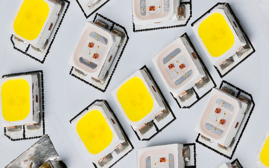 Electric light sources of yellow and white color temperature on printed wiring board detail. Surface mount assembly