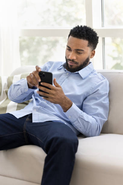 istock Serious young African business man resting on soft couch 2066617764