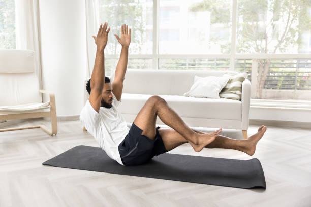 istock Concentrated athletic Black man training strong body at home 2066635693