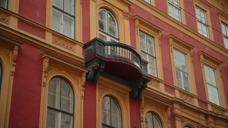 Small balcony of an old residential building, Exterior of a beautifully renovated historic apartment building in Budapest, Hungary, Hungarian architecture, colourful facade, large windows, urban, city