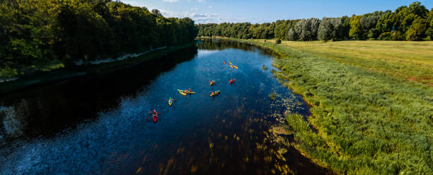 istock Kayakers enjoying a peaceful paddle on a calm river amidst expansive countryside 2066646907