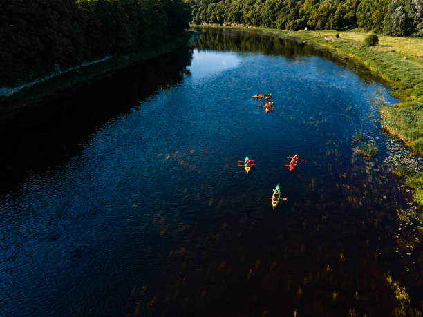 istock Tranquil kayaking scene on a wide river, surrounded by lush forest and clear skies 2066646920