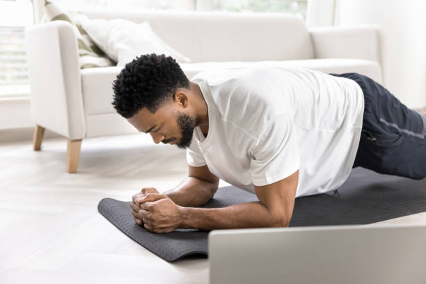 istock Focused strong sporty Black man training body at laptop 2066686127
