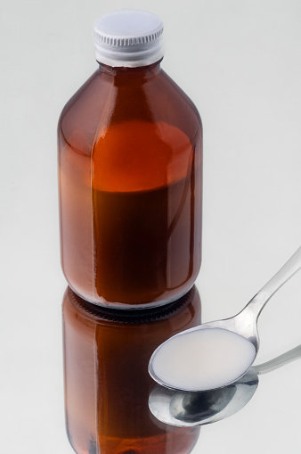 Bottle of syrup for cough, throat, parasites