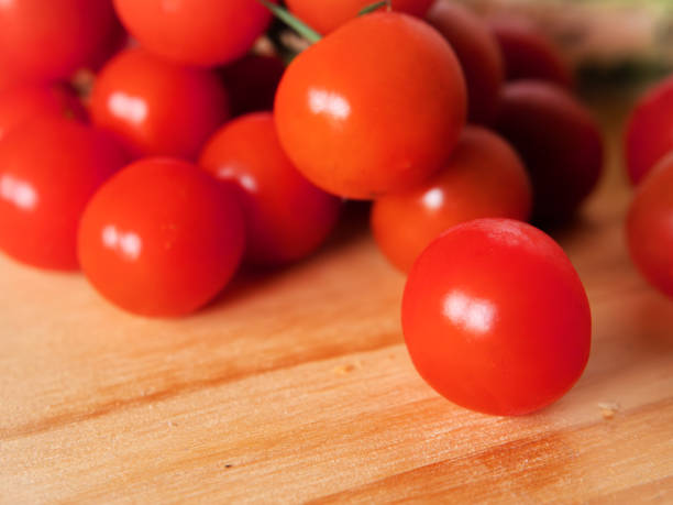 istock Close-up of Fresh Cherry Tomatoes on Wooden Surface 2066687169