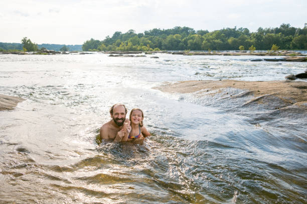 istock Father and daughter swimming in the river 2066696088