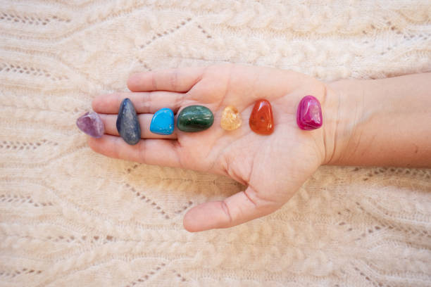 istock Healing crystals on female hand background, seven chakra stones 2066697130