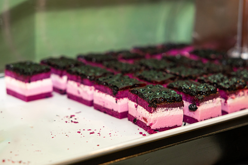 Vibrant Berry Cheesecake Squares on Display at a Hotel Buffet