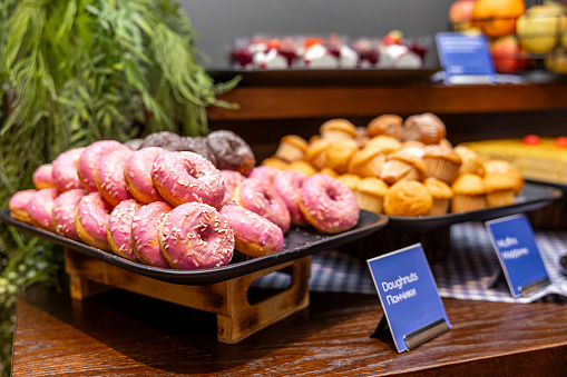 Decadent Donuts and Muffins Display at a Sweet Breakfast Buffet in hotel
