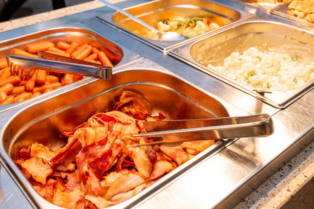 istock Hot Breakfast Buffet Selection with Bacon, Sausages, and Scrambled Eggs on Display in hotel 2066705059