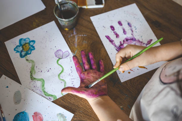 istock Children's drawing workshop, happy children make handprints with paint 2066711934