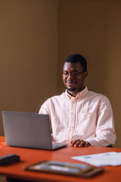 istock Smiling Businessman Working on Laptop in Modern Office Setting 2066722646