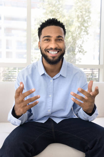 Happy handsome young African blogger man taking self video Happy handsome young African blogger man taking self video, speaking at camera, laughing, smiling, moving hands, talking on video conference call. Online conference screen head shot portrait webcam view man stock pictures, royalty-free photos & images