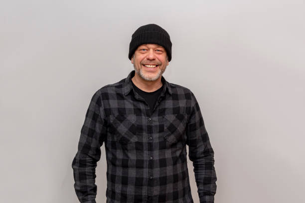istock Happy man 45-50 years old in a black hat standing on a white background 2066808010