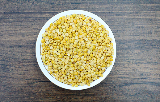 Toor dal or arhar dal in a plate on wooden background top view